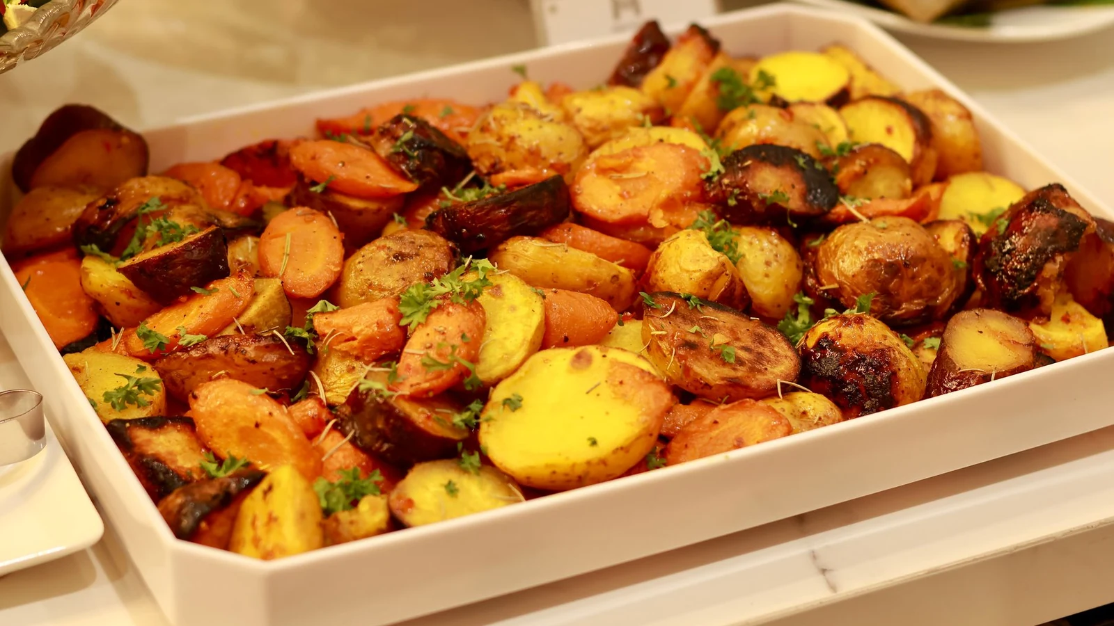 Roasted potatoes browning in a baking tray