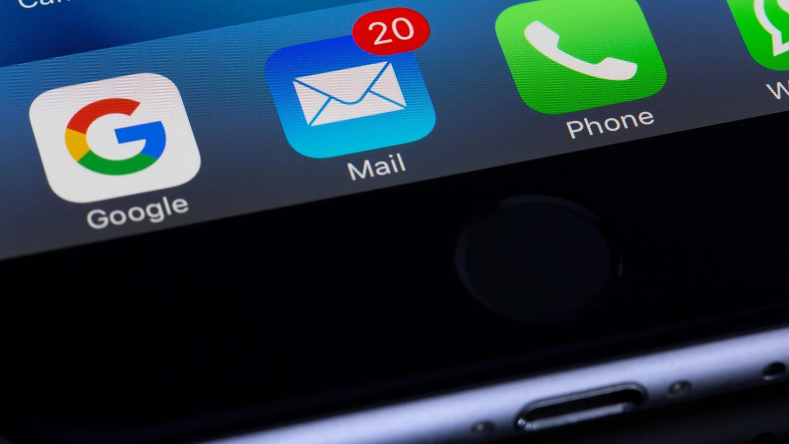 A phone home screen with a mail icon showing twenty unread messages